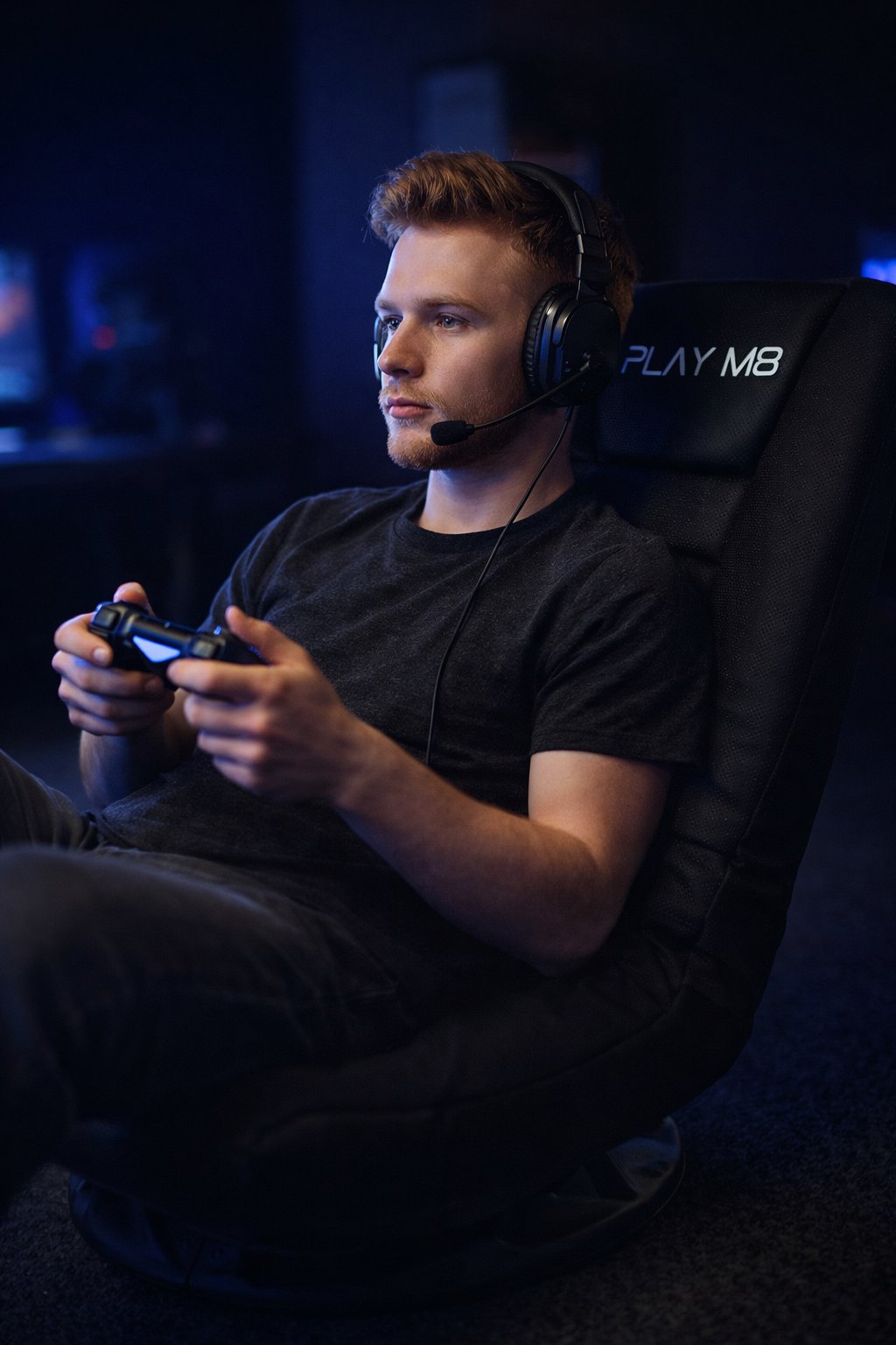 Gamer with PlayStation controller in Play M8 console chair